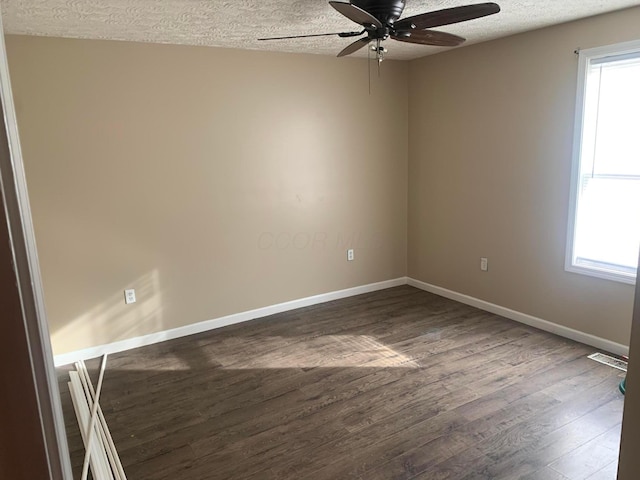 spare room with ceiling fan, dark hardwood / wood-style flooring, and a textured ceiling