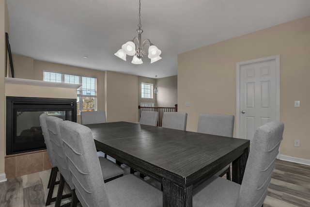 dining area with a chandelier and wood-type flooring