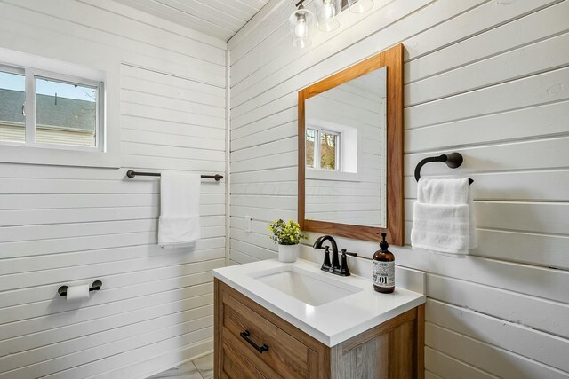 bathroom featuring wood walls