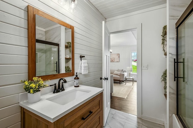 bathroom with vanity, hardwood / wood-style flooring, and wooden walls