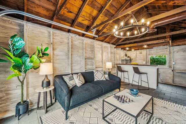 living room featuring wood ceiling, lofted ceiling, wooden walls, and a chandelier