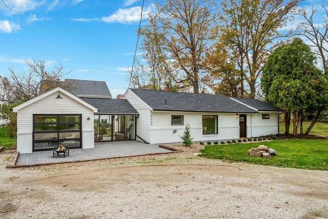 rear view of property with a patio area and a yard