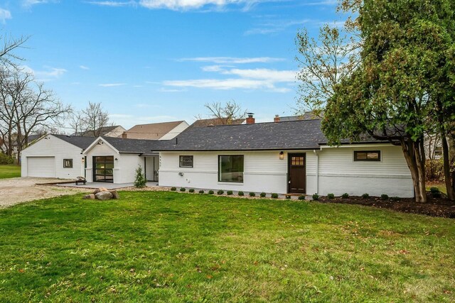 single story home with a front yard and a garage