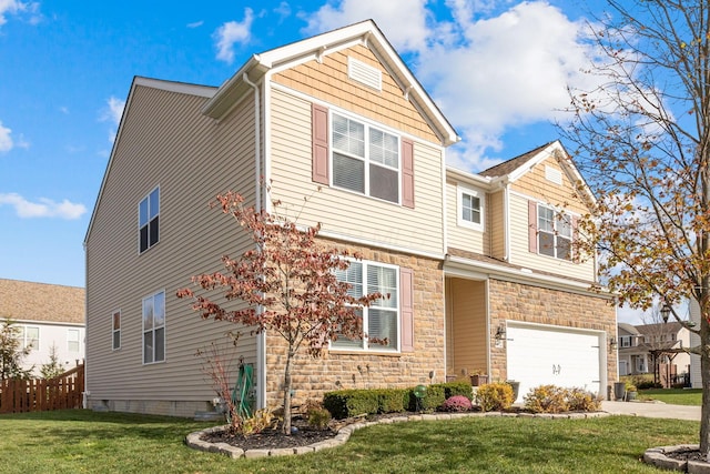 view of front of home featuring a front yard and a garage