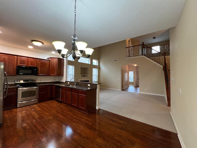 kitchen with sink, appliances with stainless steel finishes, dark hardwood / wood-style flooring, decorative light fixtures, and a chandelier