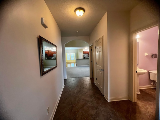 hallway featuring a textured ceiling