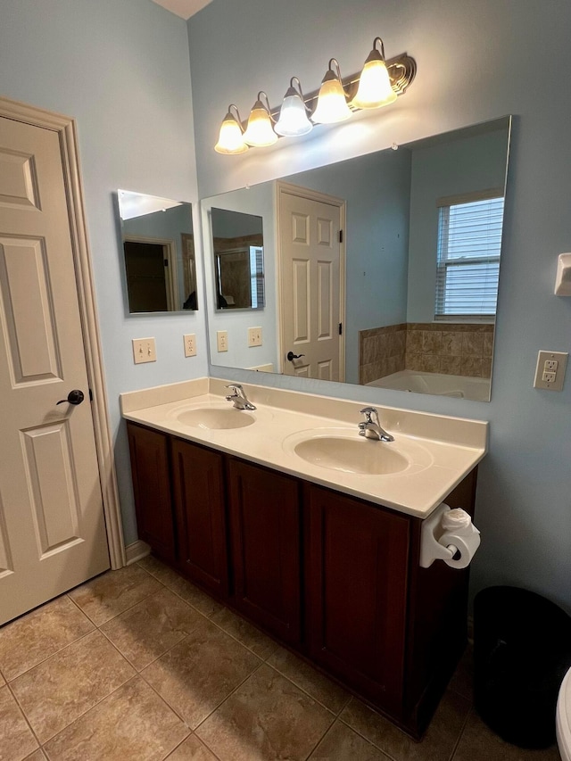 bathroom featuring tile patterned floors, vanity, and a bathing tub