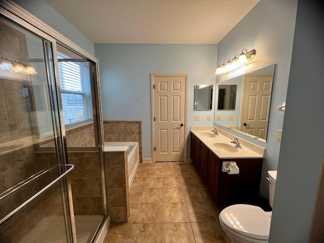 full bathroom with tile patterned flooring, vanity, shower with separate bathtub, and toilet