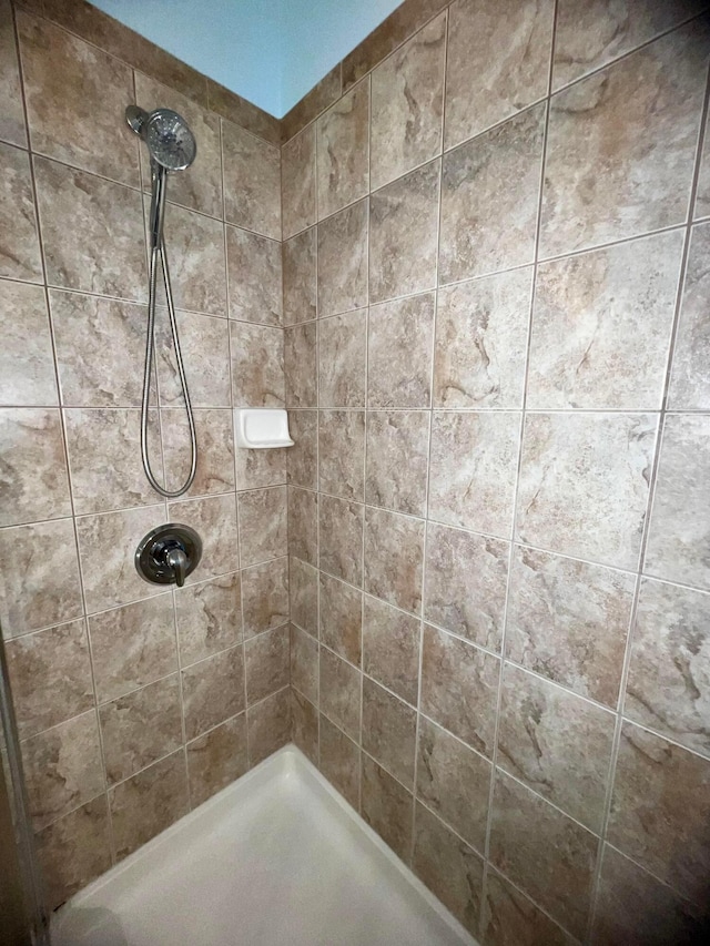 bathroom with a tile shower