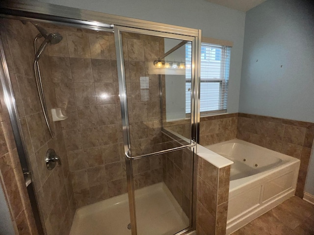 bathroom featuring tile patterned flooring and independent shower and bath