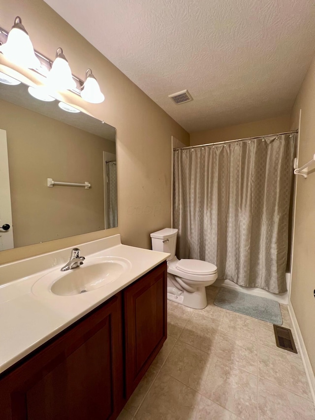 full bathroom featuring vanity, a textured ceiling, toilet, and shower / tub combo with curtain