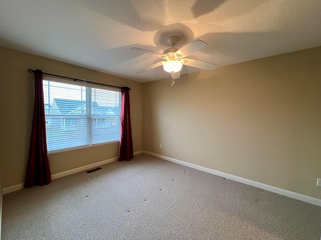 carpeted empty room with a textured ceiling and ceiling fan