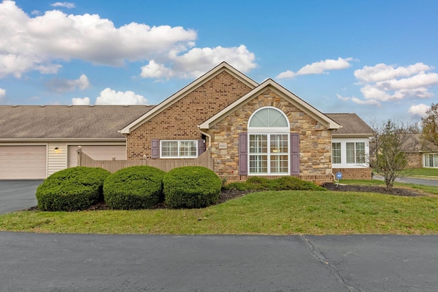 view of front facade with a front yard and a garage