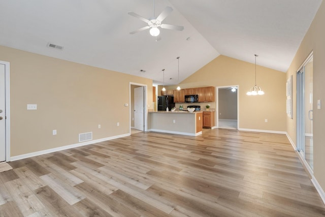 unfurnished living room with high vaulted ceiling, ceiling fan with notable chandelier, and light wood-type flooring