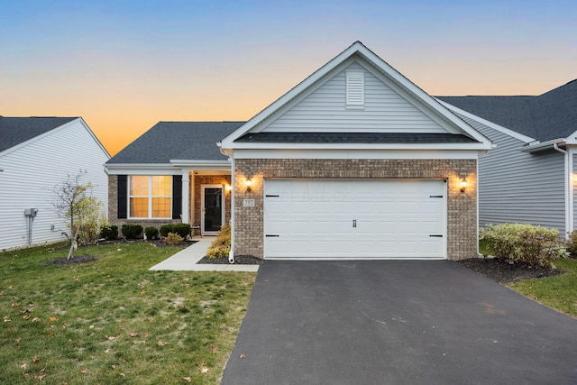 view of front of home featuring a yard and a garage