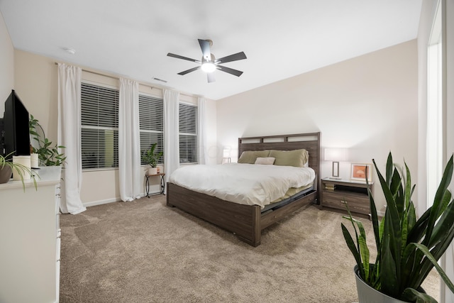 bedroom with ceiling fan and light carpet