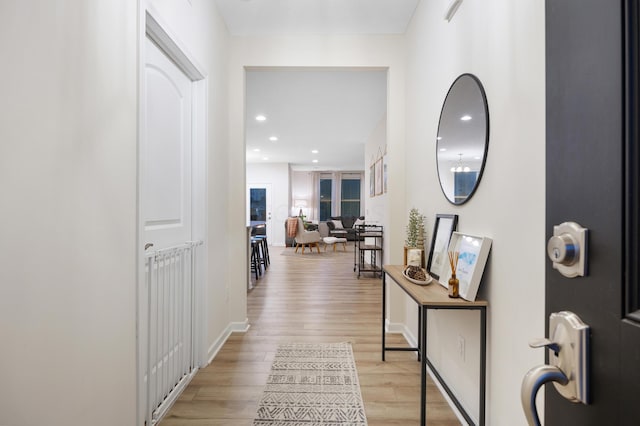 corridor with light hardwood / wood-style floors