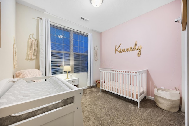 carpeted bedroom with a nursery area