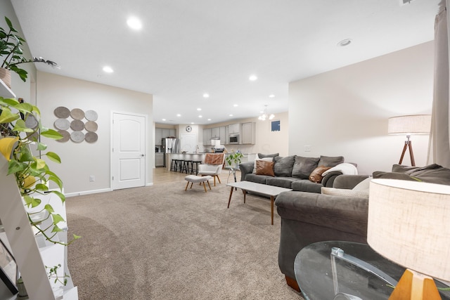 living room featuring a notable chandelier and light carpet