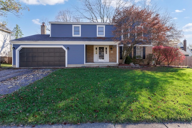 view of front property with covered porch, a front yard, and a garage