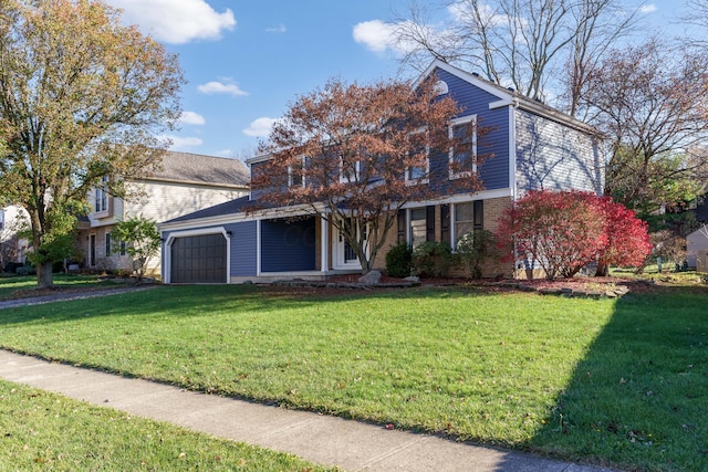 view of property featuring a front lawn and a garage