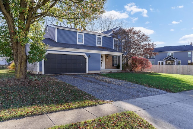 view of front property featuring a front yard, a garage, and covered porch