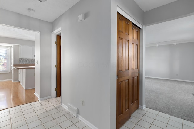 corridor featuring light tile patterned flooring