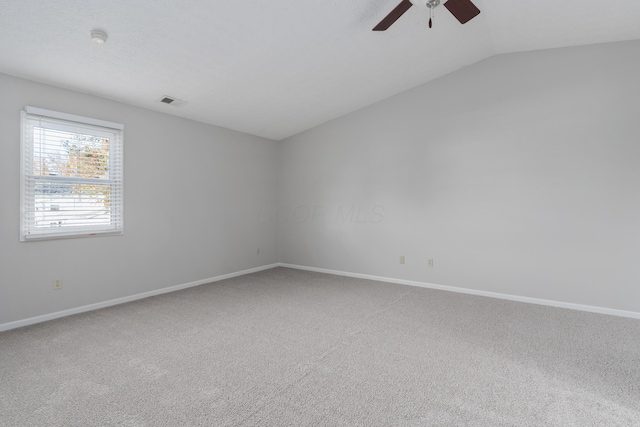 spare room with carpet floors, ceiling fan, and lofted ceiling