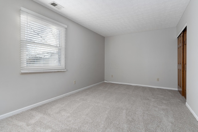 unfurnished bedroom with carpet floors and a textured ceiling