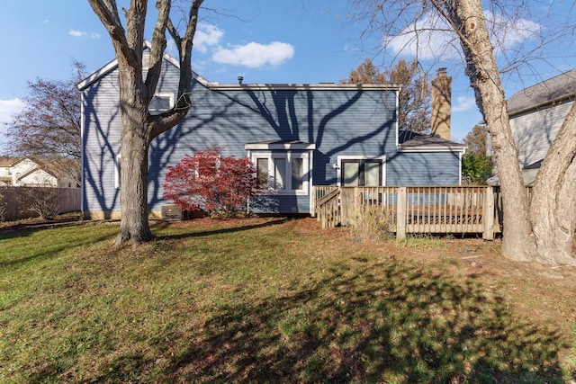 back of property featuring a yard and a deck