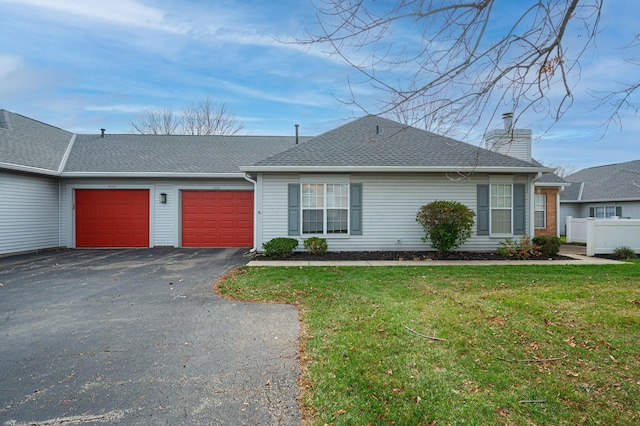 single story home featuring a garage and a front lawn