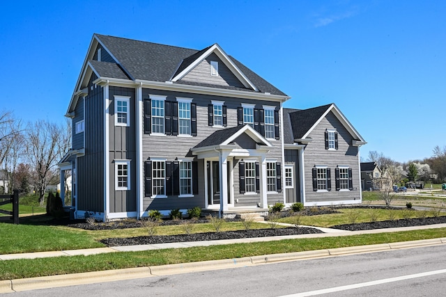 colonial home featuring a front lawn