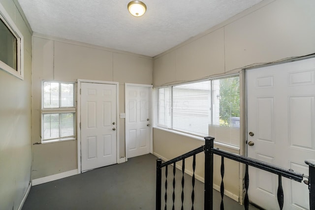 entrance foyer with a wealth of natural light and a textured ceiling