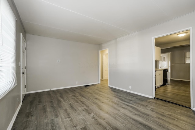 unfurnished room with dark hardwood / wood-style flooring