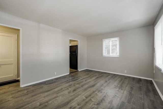 empty room with dark hardwood / wood-style floors