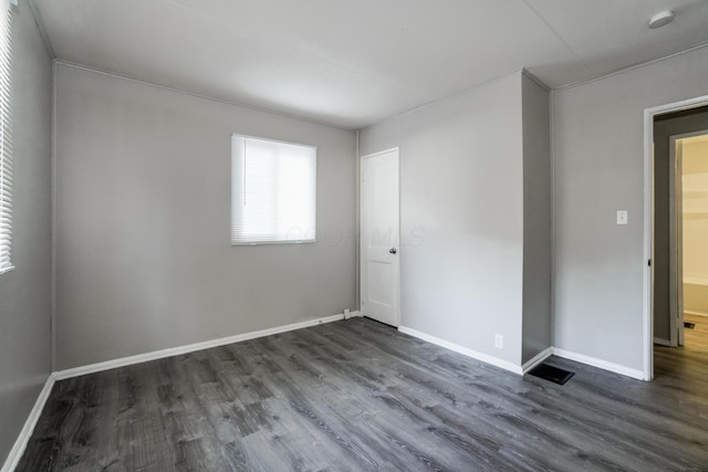 empty room featuring dark wood-type flooring