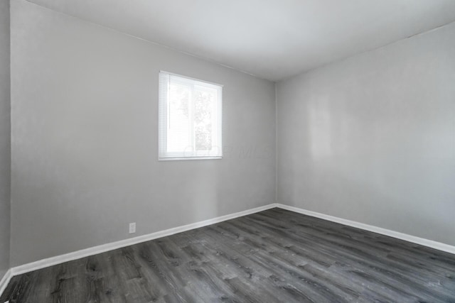 unfurnished room featuring dark hardwood / wood-style flooring