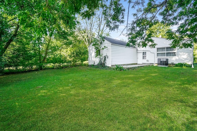 view of yard featuring central air condition unit and a patio