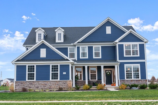 craftsman inspired home featuring a front yard and a porch