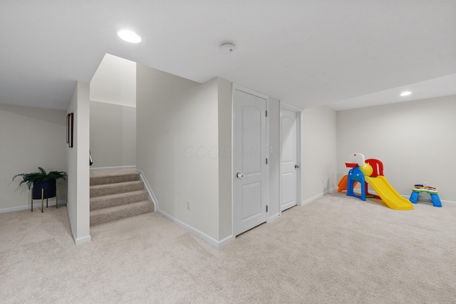 game room with light colored carpet