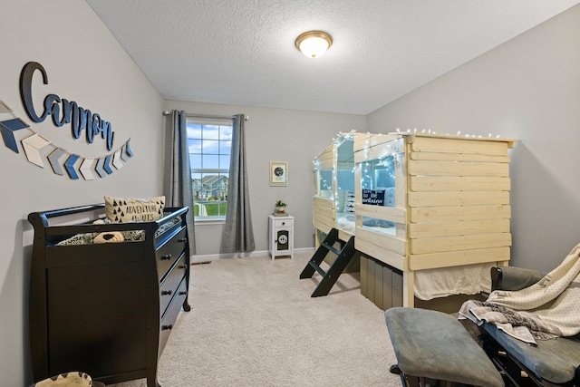 carpeted bedroom with a textured ceiling