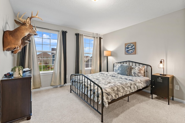 carpeted bedroom featuring a textured ceiling