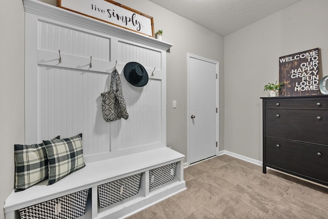 mudroom with a textured ceiling