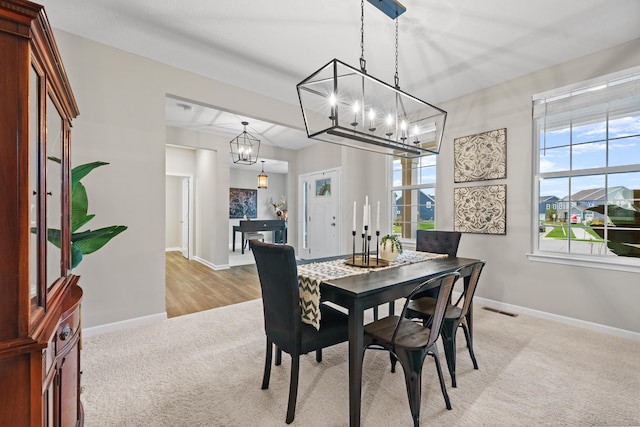 dining room featuring light hardwood / wood-style floors and a notable chandelier