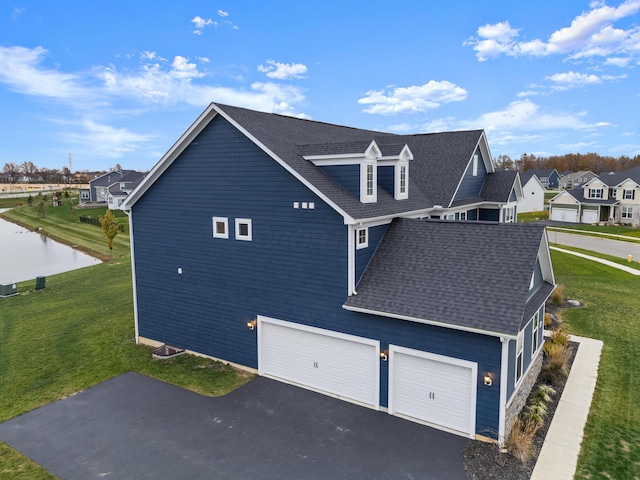 view of home's exterior with a garage and a yard