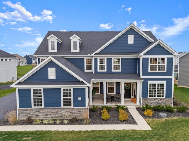 craftsman house featuring a front lawn and covered porch