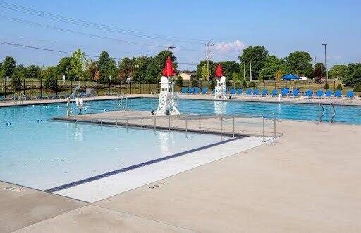 view of pool featuring pool water feature and a patio