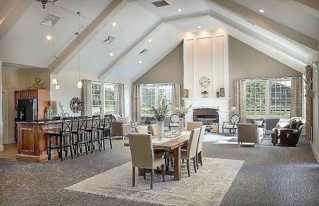 dining room featuring high vaulted ceiling, dark carpet, and a wealth of natural light