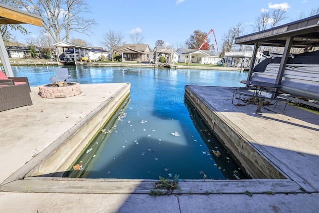 view of pool featuring a water view and an outdoor fire pit