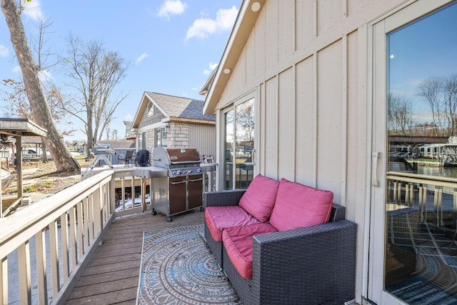 wooden deck with a grill and a water view